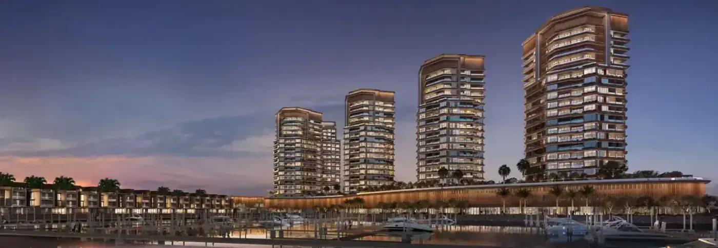 Night-time developer rendering of Al Hamra Waterfront towers and marina