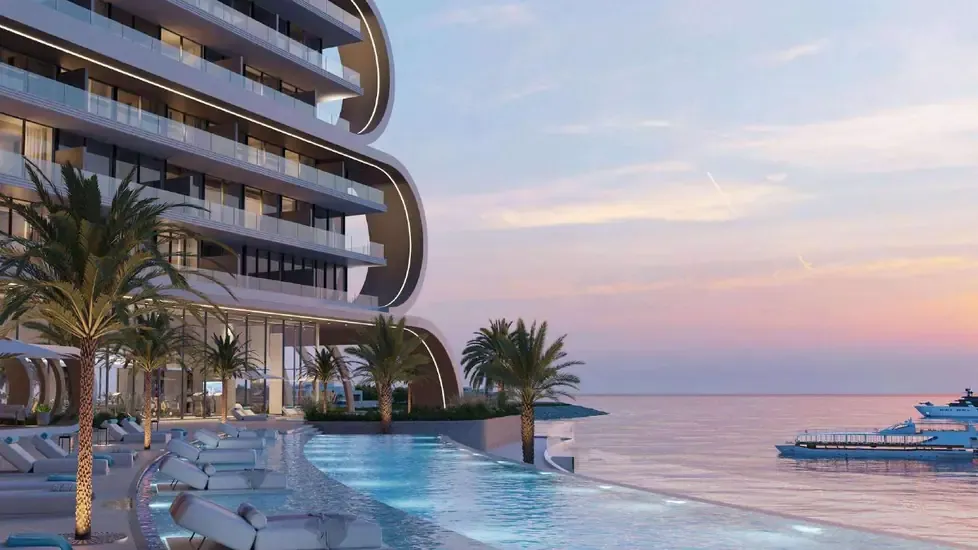 JW Marriott Residences Al Marjan Island waterfront pool deck at sunset