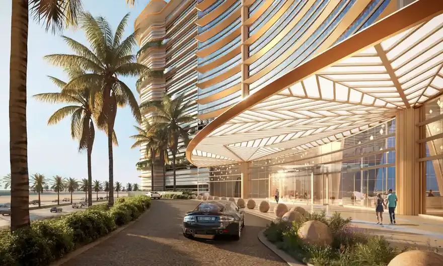 Arrival and covered drop-off framed by the curved facade
